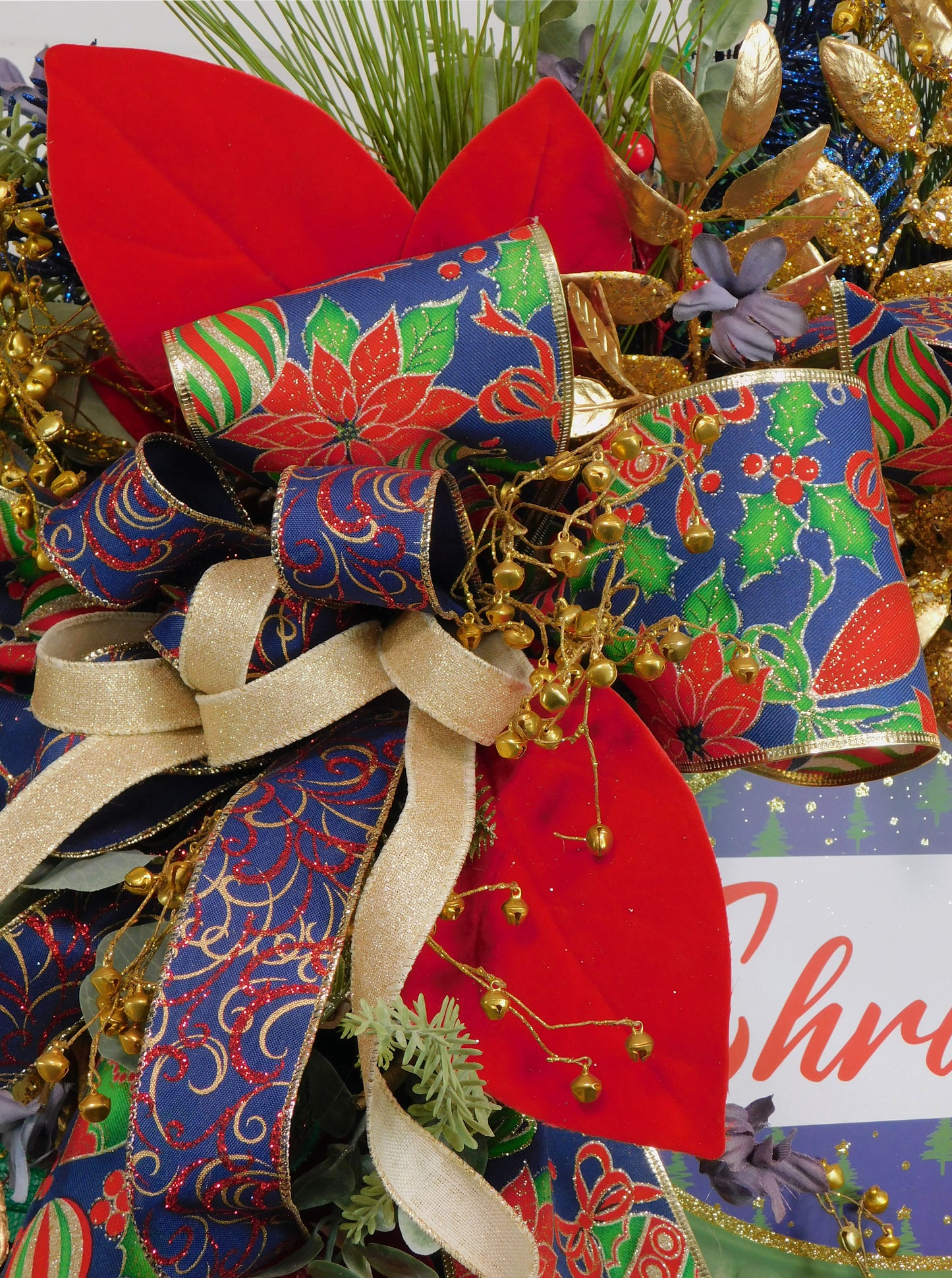 Festive Christmas Wreath with Gold Accents, Red and Green Poinsettia Ribbon, Glittery Ornaments, and 'Merry Christmas' Sign – Elegant Holiday Door Decor